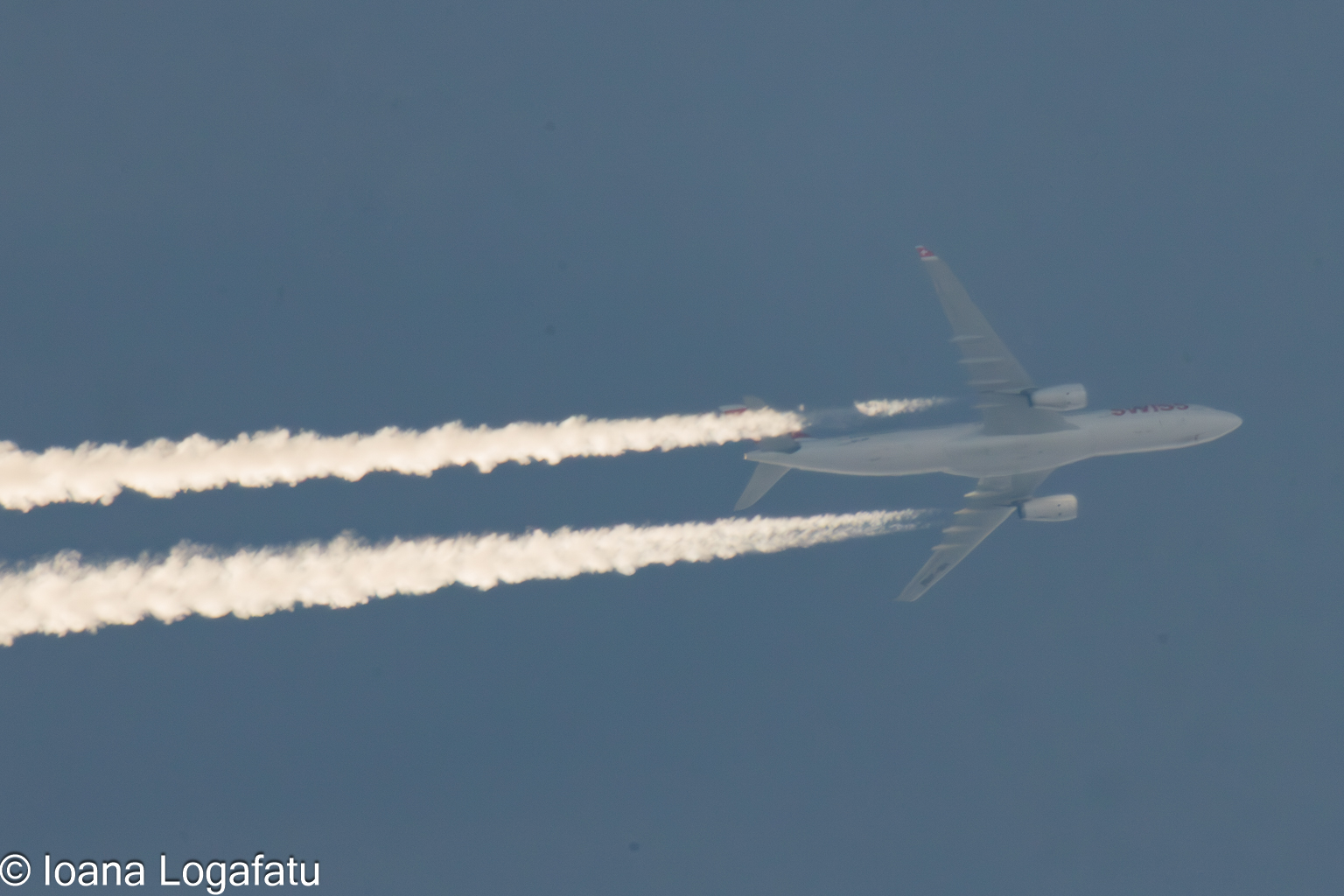 Majestic aircraft cuts through the clear blue sky